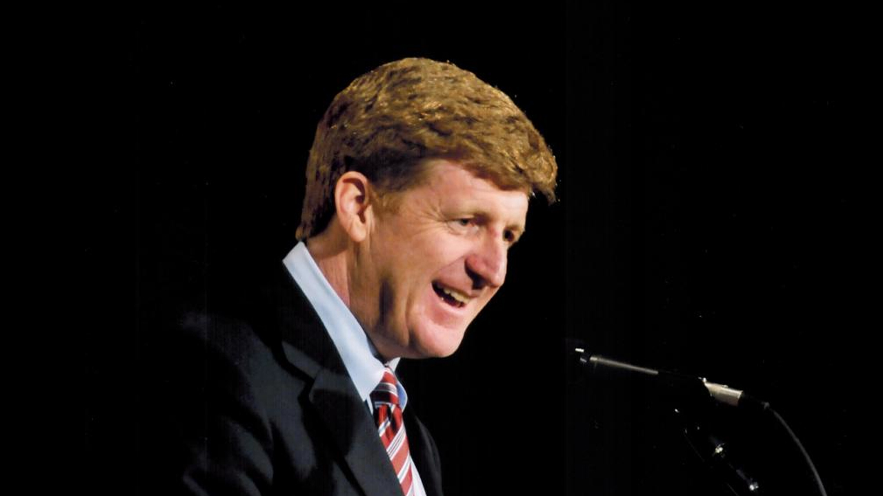 Patrick J. Kennedy speaks from a podium